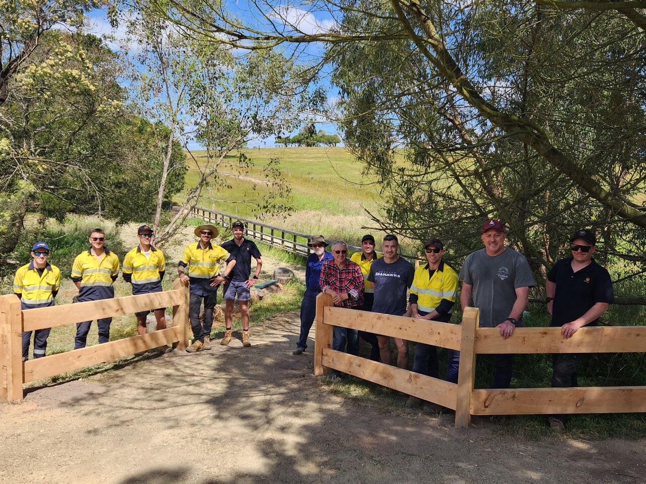 Loy Yang B maintenance workers with some of the fencing they built during a volunteer day at the Traralgon Railway Reservoir Conservation Reserve.