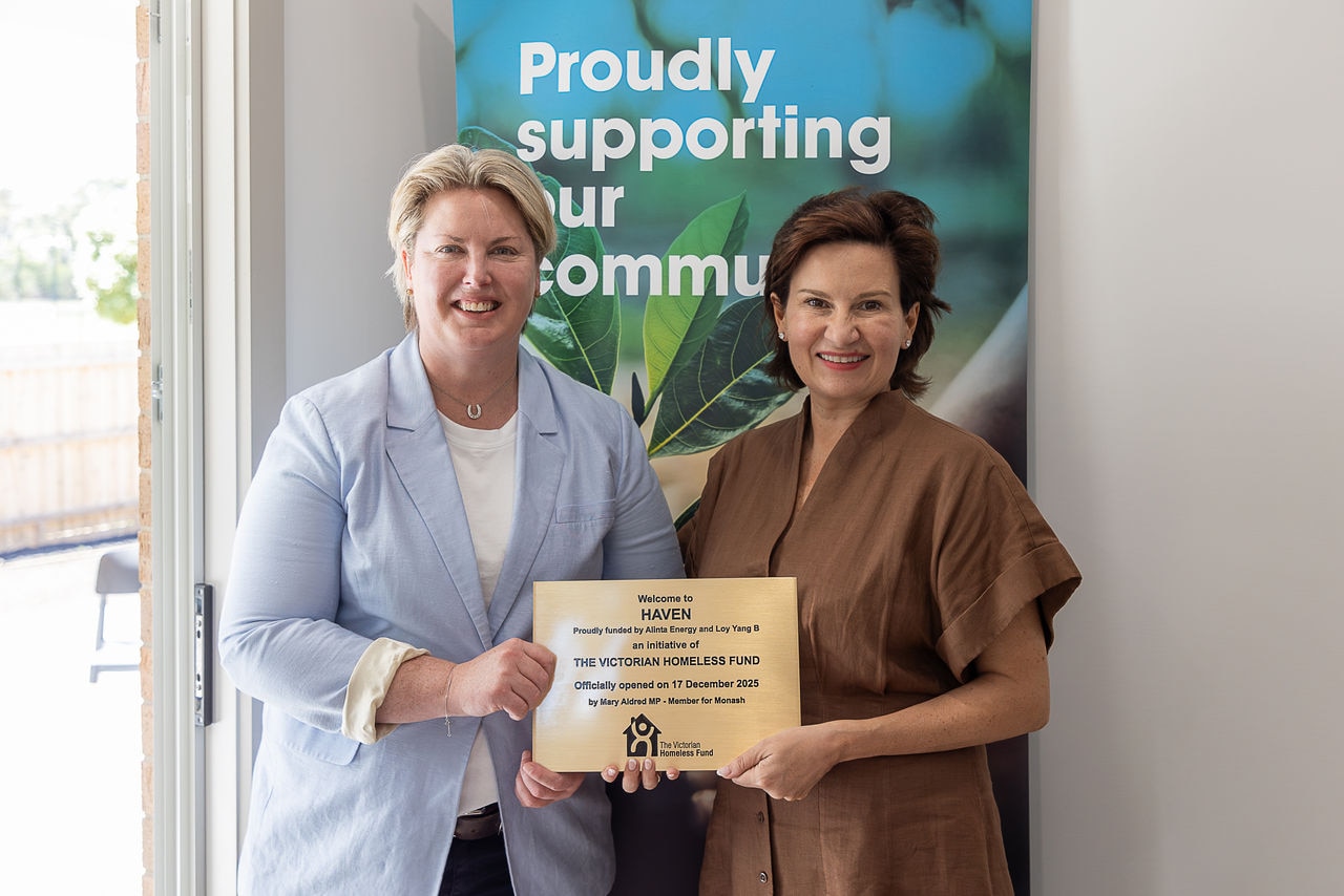 Federal MP for Monash Mary Aldred (left) and Alinta Energy Executive Director of Corporate Affairs Sarah McNamara stand next to each other holding a plaque celebrating the opening of Haven.